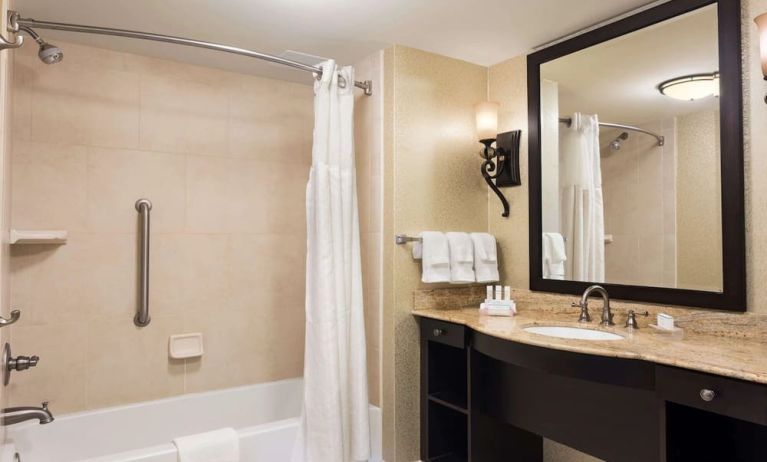 Guest bathroom with shower and bath at Homewood Suites By Hilton Lafayette-Airport, LA.