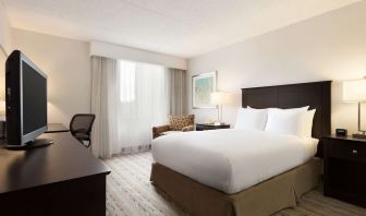 King bed room with TV and work desk at DoubleTree By Hilton Hartford - Bradley Airport.