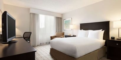 King bed room with TV and work desk at DoubleTree By Hilton Hartford - Bradley Airport.