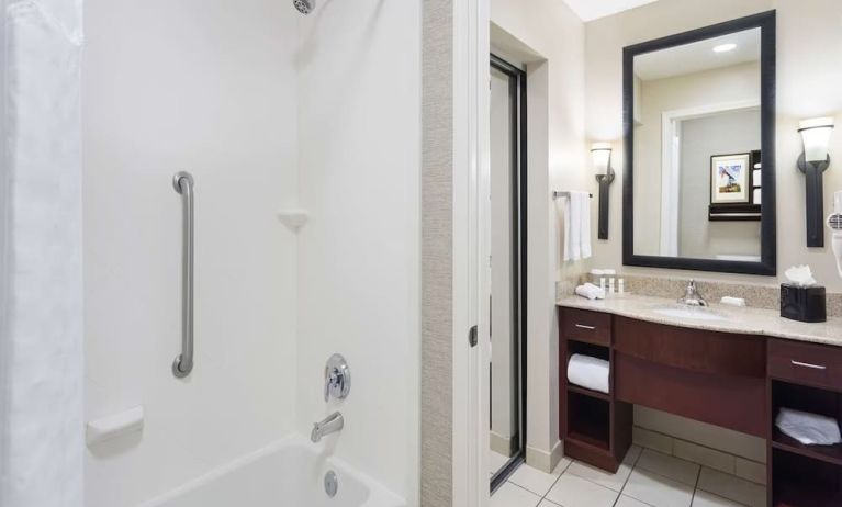 Guest bathroom with shower and bath at Homewood Suites By Hilton Shreveport / Bossier City, LA.