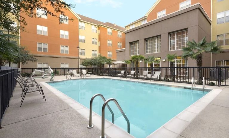 Outdoor pool with seating area at Homewood Suites By Hilton Shreveport / Bossier City, LA.