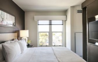 King bed with natural light at Hyatt Place Charleston - Historic District.