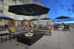 Relaxing outdoor terrace with fire pits at Hilton Baton Rouge Capitol Center.