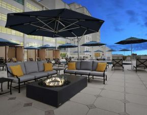 Relaxing outdoor terrace with fire pits at Hilton Baton Rouge Capitol Center.
