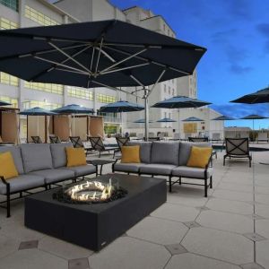 Relaxing outdoor terrace with fire pits at Hilton Baton Rouge Capitol Center.