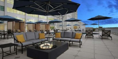 Relaxing outdoor terrace with fire pits at Hilton Baton Rouge Capitol Center.