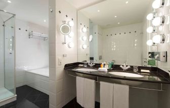 Guest bathroom with shower at Hilton Berlin.