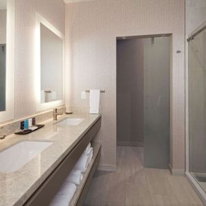 Guest bathroom with shower at H Hotel Los Angeles, Curio Collection By Hilton.