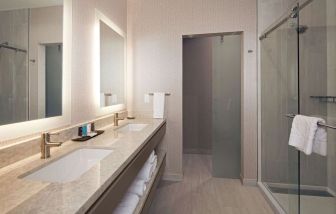 Guest bathroom with shower at H Hotel Los Angeles, Curio Collection By Hilton.