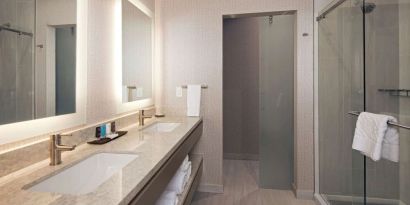 Guest bathroom with shower at H Hotel Los Angeles, Curio Collection By Hilton.