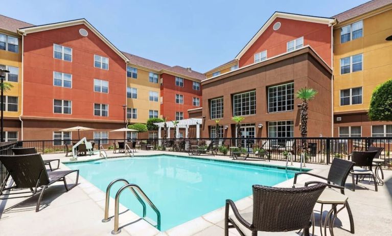 Stunning outdoor pool with pool chairs at Homewood Suites By Hilton Shreveport.