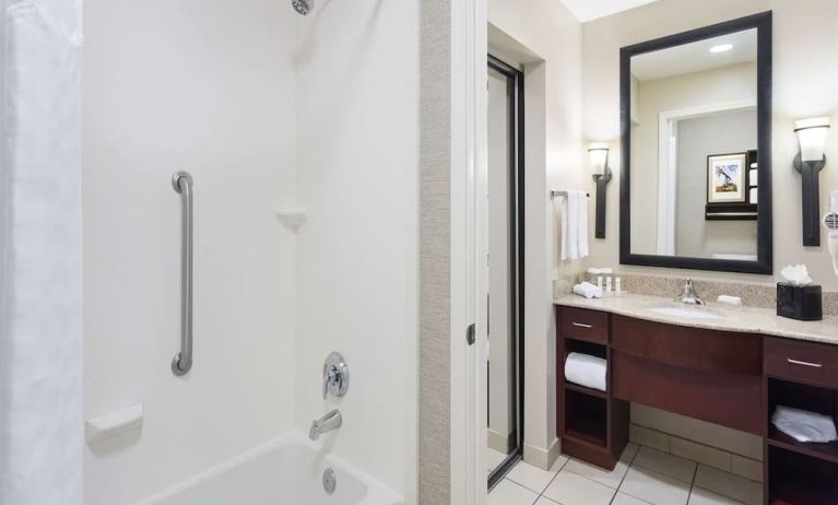 Guest bathroom with shower and bath at Homewood Suites By Hilton Shreveport.