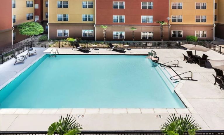 Relaxing outdoor pool and seating area at Homewood Suites By Hilton Shreveport.