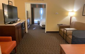 Spacious king bed with TV and lounge area at Holiday Inn Express & Suites Scottsdale - Old Town.