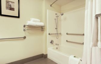 Guest bathroom with bath and shower at Holiday Inn Express & Suites Scottsdale - Old Town.