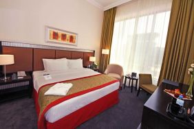 Delux king room with natural light at Millennium Central Doha.