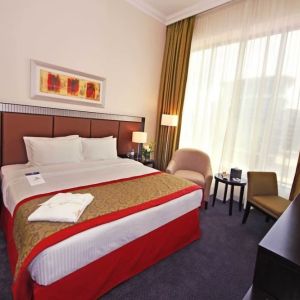 Delux king room with natural light at Millennium Central Doha.