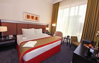 Delux king room with natural light at Millennium Central Doha.