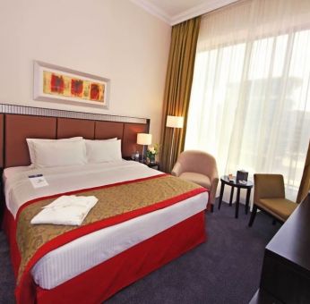 Delux king room with natural light at Millennium Central Doha.