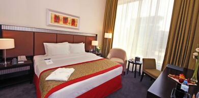 Delux king room with natural light at Millennium Central Doha.