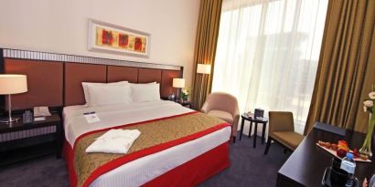 Delux king room with natural light at Millennium Central Doha.