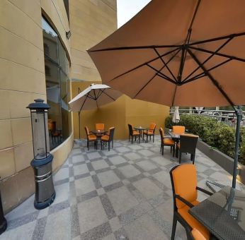 Outdoor terrace and coworking space at Millennium Central Doha.