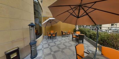 Outdoor terrace and coworking space at Millennium Central Doha.