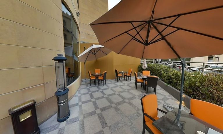 Outdoor terrace and coworking space at Millennium Central Doha.