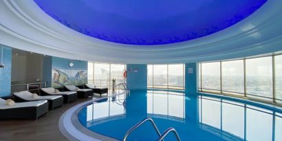 Relaxing indoor pool and pool area at Millennium Hotel Doha.