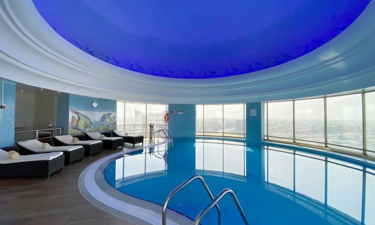 Relaxing indoor pool and pool area at Millennium Hotel Doha.