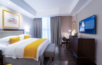 King bed with TV at Millennium Hotel Doha.