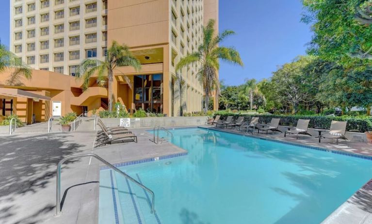 Outdoor pool area with lounges at the DoubleTree by Hilton Anaheim/Orange County.