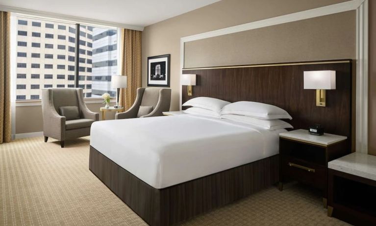 King bed with natural light at Hilton Indianapolis Hotel & Suites.