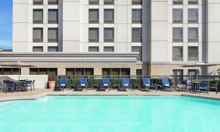 Relaxing pool area with pool chairs at Hampton Inn Dallas-Irving-Las Colinas.