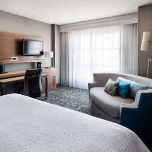 Delux king bed with TV at Sonesta Emeryville - San Francisco Bay Bridge.