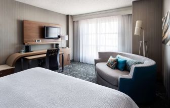 Delux king bed with TV at Sonesta Emeryville - San Francisco Bay Bridge.