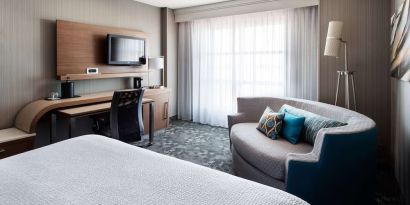 Delux king bed with TV at Sonesta Emeryville - San Francisco Bay Bridge.