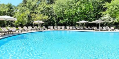 Luxurious outdoor pool with pool chairs at Hilton Short Hills.