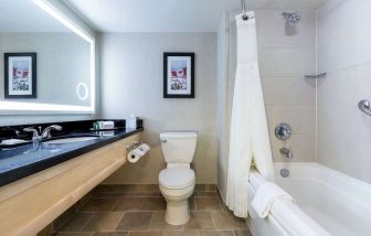 Guest bathroom with shower and bath at Hilton Whistler Resort & Spa.