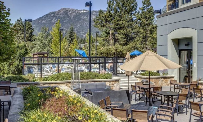 Outdoor terrace set in a lovely garden at Hilton Whistler Resort & Spa.