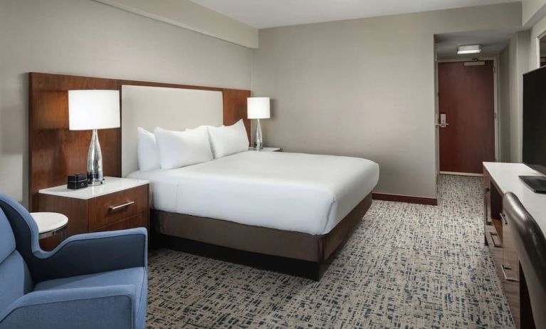 King bed with TV and work desk at Hilton Boston Logan Airport.