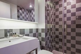 Guest bathroom with shower at Best Western Premier Empire State Hotel.