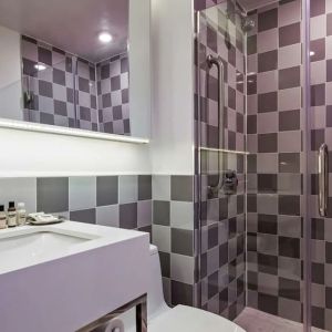 Guest bathroom with shower at Best Western Premier Empire State Hotel.