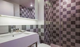 Guest bathroom with shower at Best Western Premier Empire State Hotel.