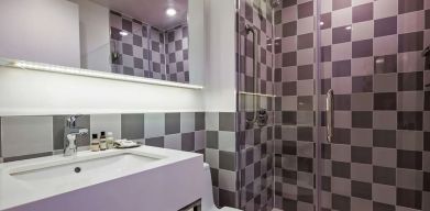 Guest bathroom with shower at Best Western Premier Empire State Hotel.