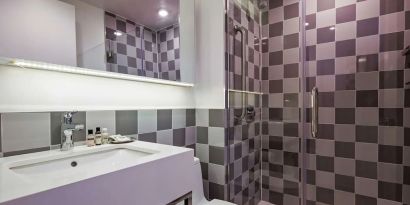 Guest bathroom with shower at Best Western Premier Empire State Hotel.