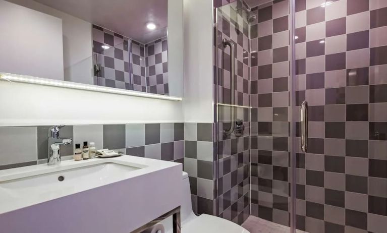 Guest bathroom with shower at Best Western Premier Empire State Hotel.