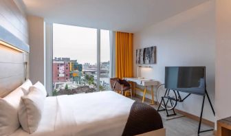 Day use room with TV and work desk at at The Envoy Hotel, Autograph Collection.