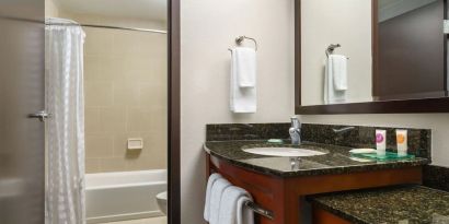 Guest bathroom with shower and tub at Hyatt PLACE Fort Lauderdale Airport - South & Cruise Port.