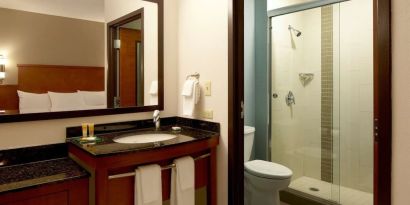 Guest bathroom with shower at Hyatt Place Chicago, Lombard / Oak Brook.